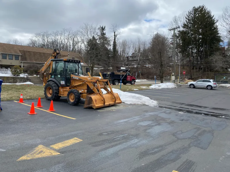 Backhoe parked in a lot.